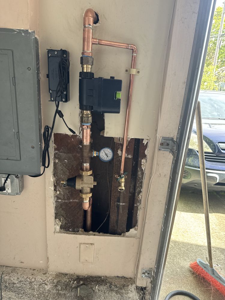 Water main shutoff valve, pressure regulating valve, and gauge installed on a commercial water supply line